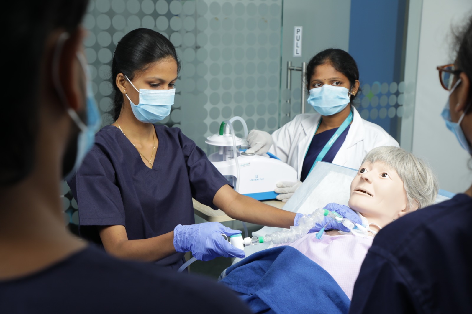 Clinical instructor guiding nursing students during a skills workshop